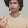 Male model applying Jam Packed Hydrating Lip balm in Bare Butter shade